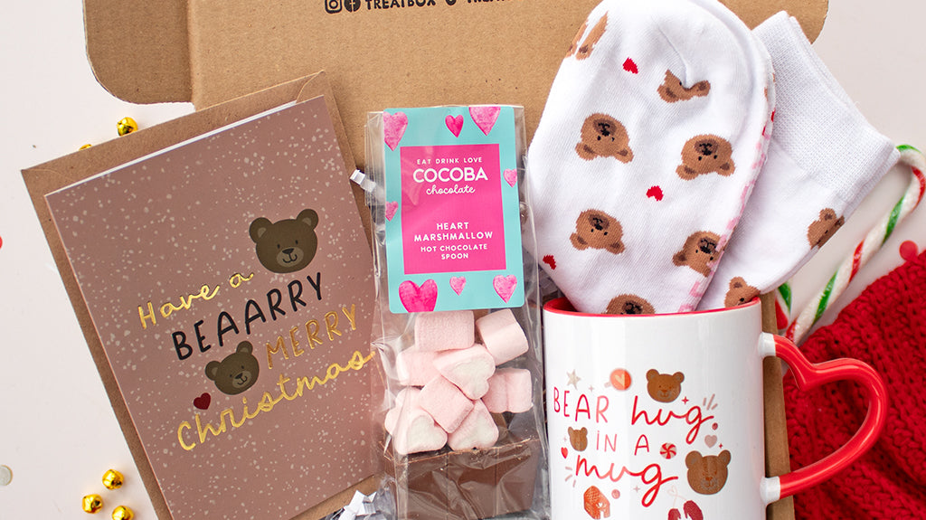 Christmas socks white with grey snowflakes and a penguin wearing festive reindeer antlers. Available via the Treatbox shop.