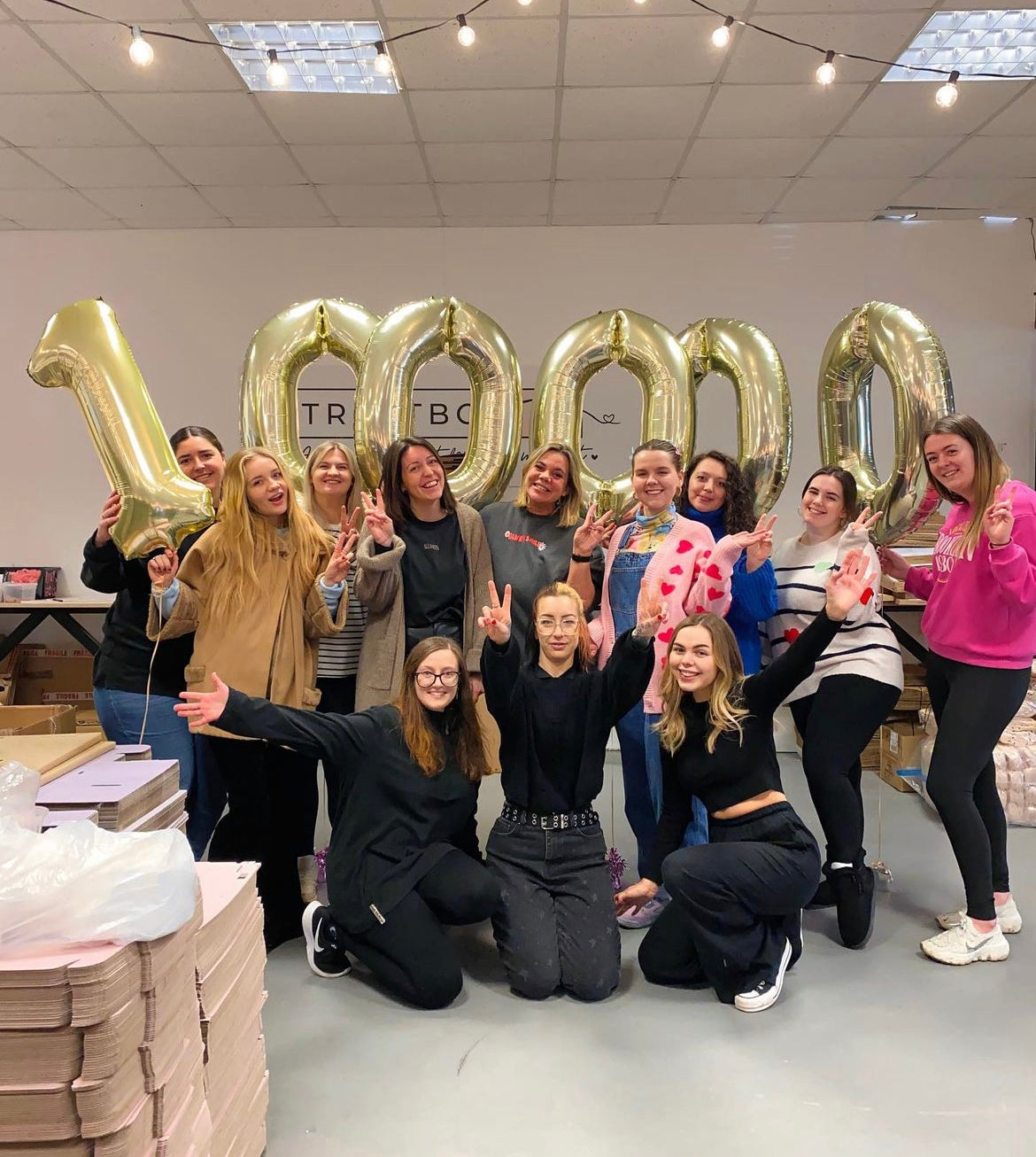 TreatBox UK team. The Team at Treatbox behind lots or large, filled Royal Mail bags with the warehouse in the background.