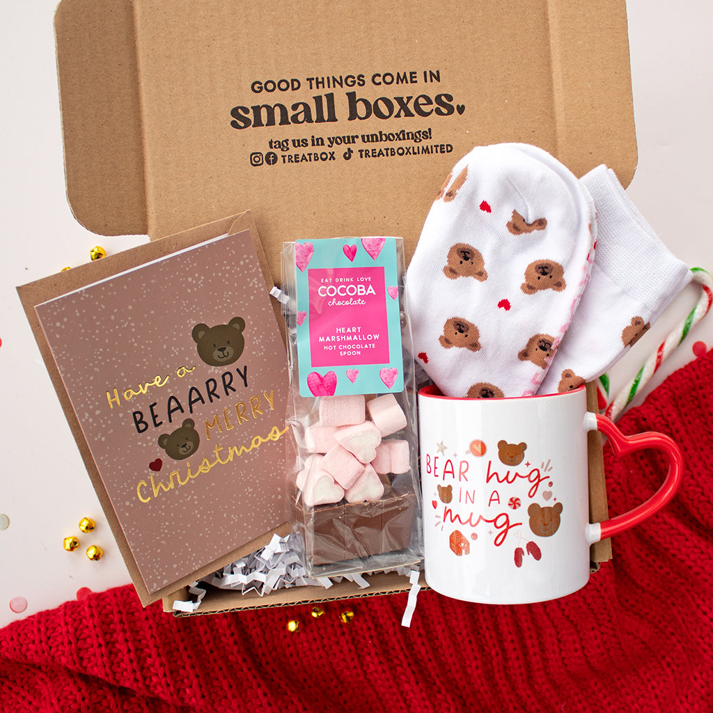 Christmas socks white with grey snowflakes and a penguin wearing festive reindeer antlers. Available via the Treatbox shop.