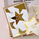 Star foil card with gold text and matching star-shaped cookie 