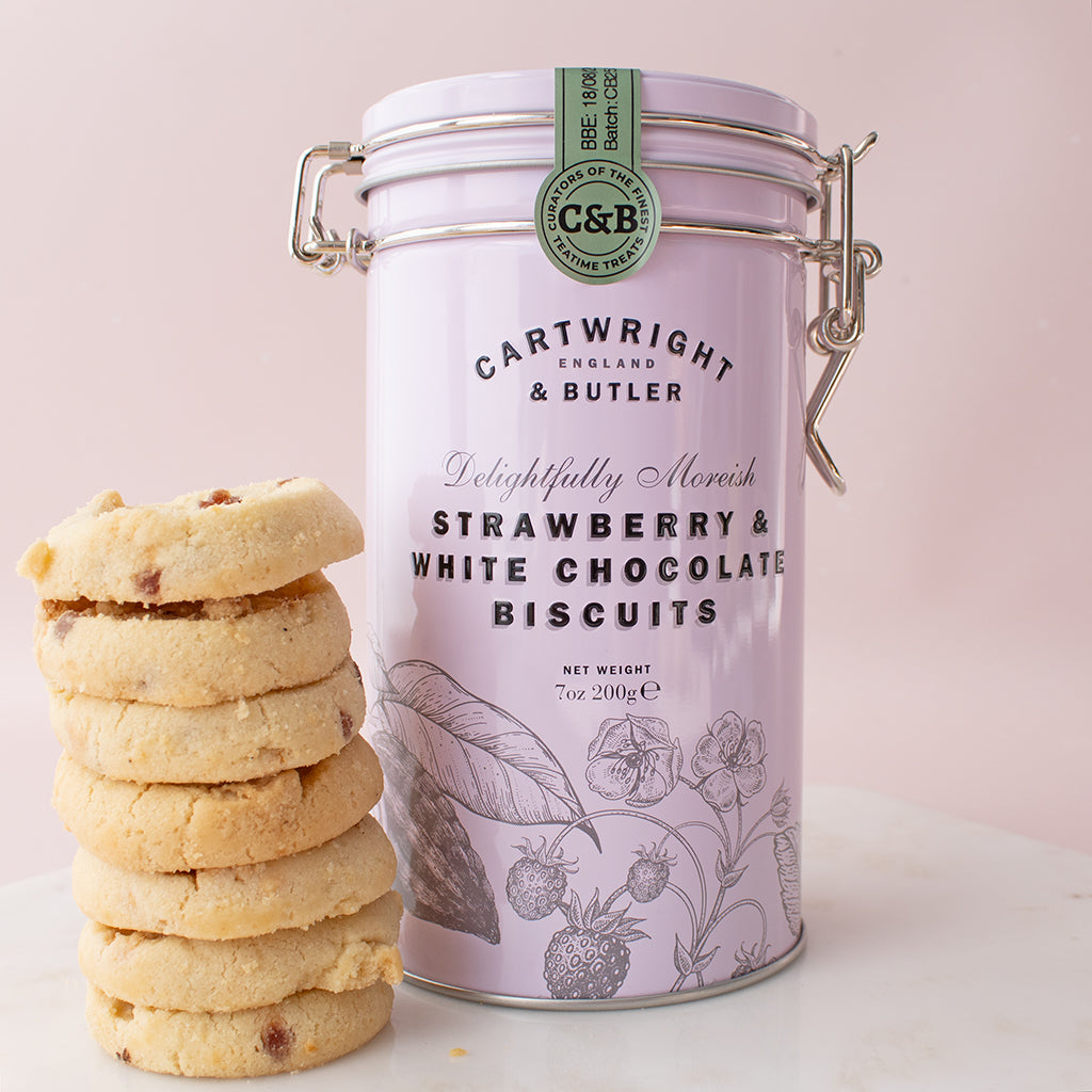 Cartwright & Butler strawberry and white chocolate biscuits with a pink packaging canister on a light background