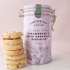 Cartwright & Butler strawberry and white chocolate biscuits with a pink packaging canister on a light background